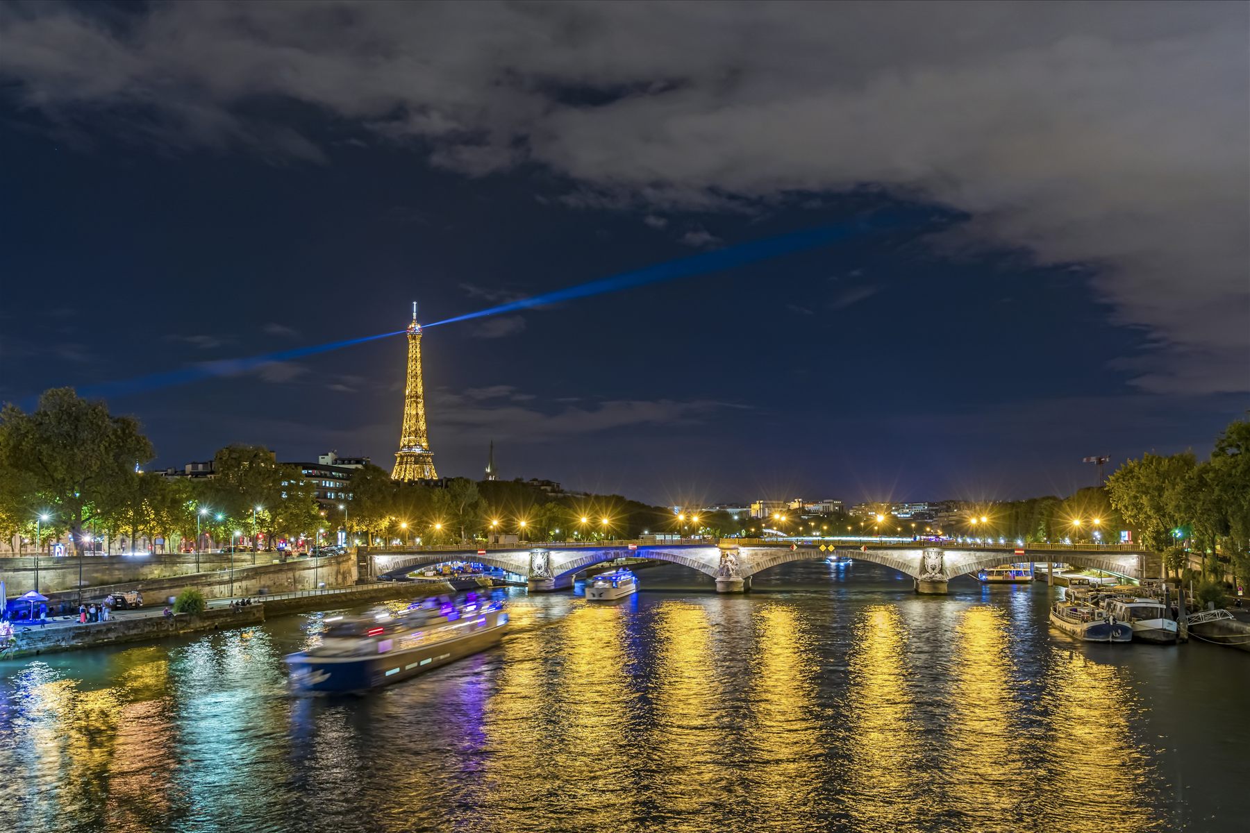 River cruise boats on the Seine below the Eiffel Tower in Paris